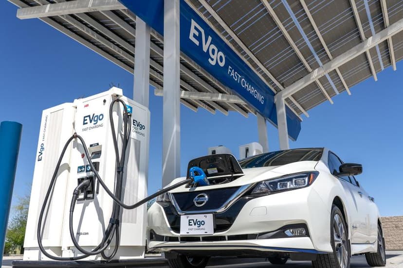 Electric vehicle at EVgo fast charging station with solar panels overhead.